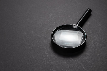 magnifying glass on black texture background with shadow.の写真素材