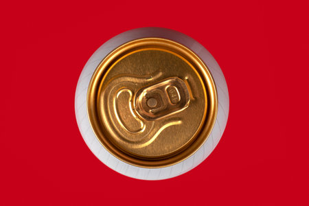 yellow beer can on red background, view from the top.