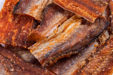 Pieces of cleaned dried fishbackground. Dry Peppered Pollack. Amber with pepper Collection.の写真素材