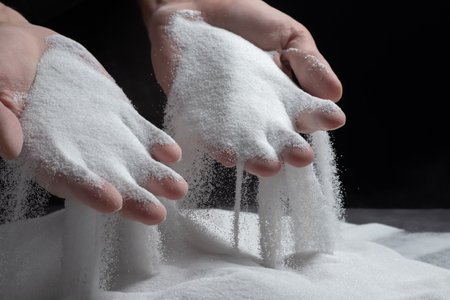 Men's hands keep sand in their palms and spilling grains of sand through their fingers. Concept of the flow of lifeの写真素材