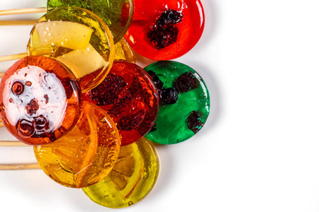 Sweet colorful lollipops with dried fruits on white background.の写真素材