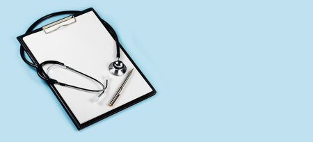 blank clipboard with modern stethoscope, space for messages.の写真素材