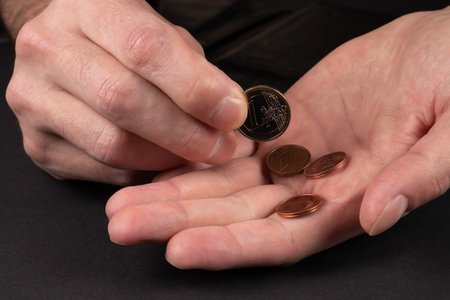 Man holds euro coins in his hands. Close up