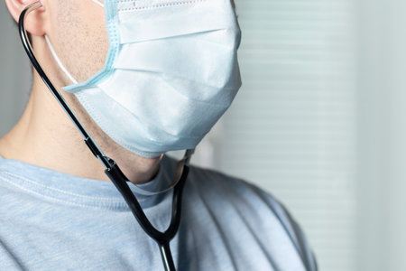 Doctor in mask with stethoscope in ear listen you carefully attentively.の写真素材