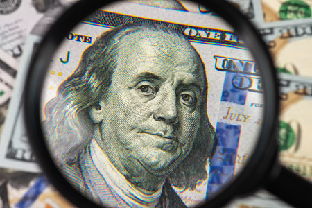 Hundred dollar banknote under magnifying glass close up.の写真素材