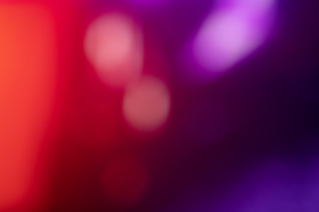 Blurred, out of focus photo, night neons bokeh, vivid blue and purple colors, cyberpunk atmosphere. Amazing wallpaper backdrop. Night city street.の写真素材