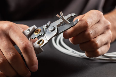 The use of the stripper cutter tool to strip the end of the electrical wire when repairing and...
