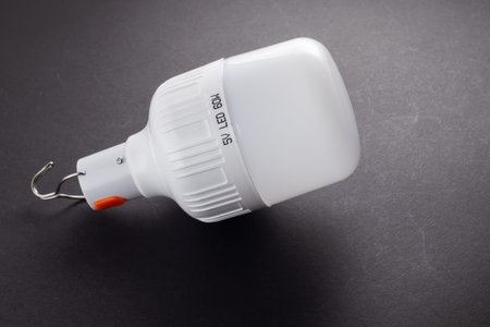 white emergency led bulbs with integrated battery on dark.