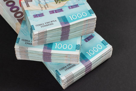 a pack of hryvnias on the table. Financial concept. Ukrainian money. 1000 hryvnia on dark backgroundの写真素材