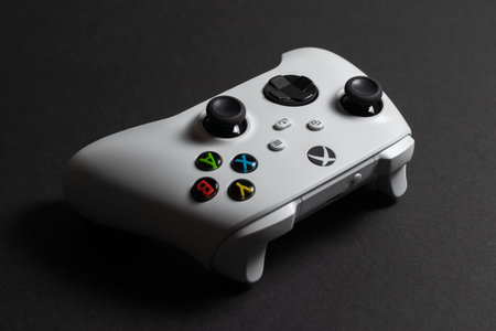 30 August, 2023 - Dnipro, Ukraine: White controller xbox Series S gamepad, game console on dark...