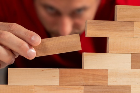 Man holding blocks wood game Build wall close upの写真素材