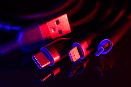 digital computer or smartphone cables. USB type c, mini-usb, lightning connector. on dark...