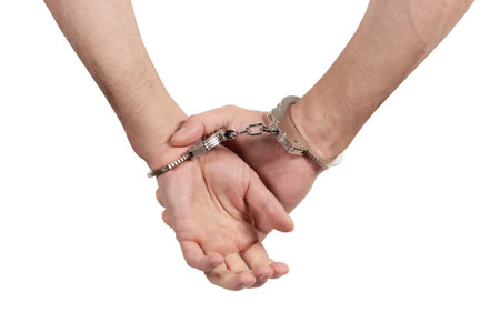 Man's hands in handcuffs on a white background, isolated.の写真素材