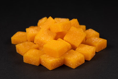 candied mango dices on dark background.の写真素材