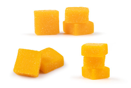 Dried and candied mango cubes on white. Set or collection, vegan, vegetarian food concept.の写真素材