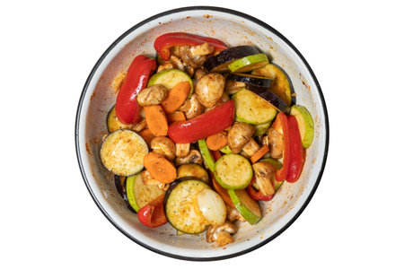 Grilled vegetables in a cast iron bowl pan on white.の写真素材