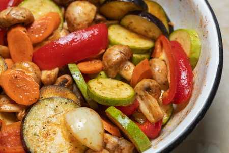 Baked seasonal vegetables with herbs, healthy vegetarian meal.の写真素材
