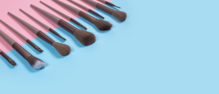 Cosmetics and beauty. Make-up brushes set in row on blue background.の写真素材