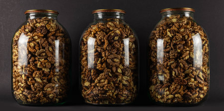 The walnut kernels in jar isolated on dark backgroundの写真素材
