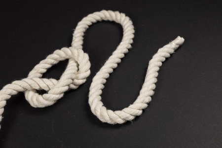 Rope with a knot on dark background.の写真素材