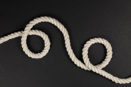 beige rope on dark background close up.の写真素材