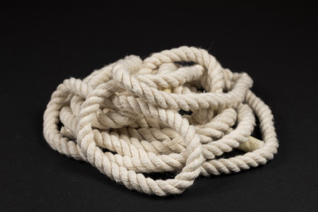 beige rope on dark background close up.の写真素材