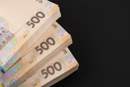a pack of hryvnias on the table. Financial concept. Ukrainian money. 500 hryvnia on dark background.