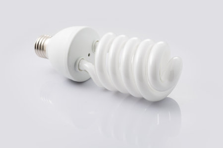 Energy saving fluorescent light bulb CFL. Isolated on white background,の写真素材