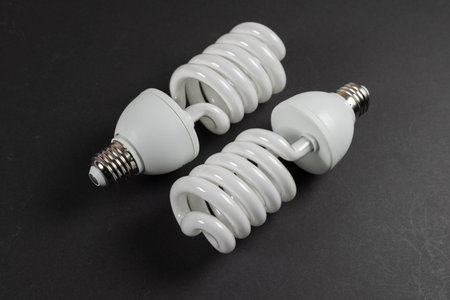 Energy saving fluorescent light bulb CFL on dark background.
