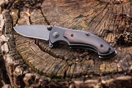Tactical knife on a wooden background.の写真素材