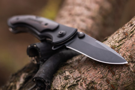 tactical knife on tree in the forest.の写真素材