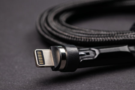 usb lightning data cable on dark background.の写真素材