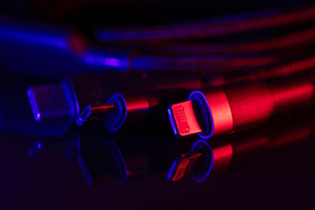 Different USB charging plugs on dark background. USB Type C, Micro USB, USB lightning.の写真素材