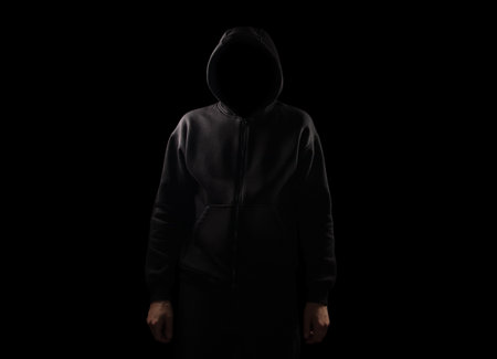 Silhouette of man in the hood over dark background with copy space,の写真素材