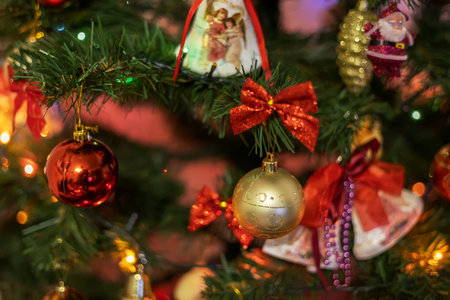 Christmas tree decorated with blue New Year's toys and golden garland