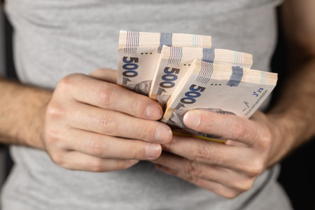 Man holding Ukrainian money 500 hryvnia banknotes. closeup