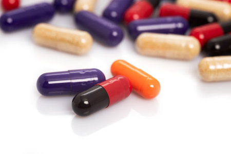 Colorful pills or capsule freely laid on a white table.の写真素材