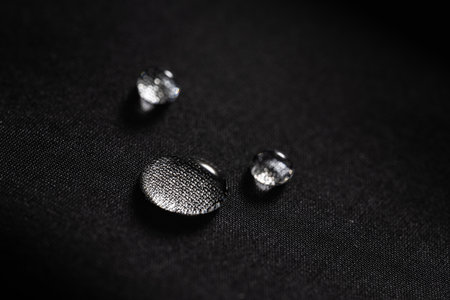 water drops on dark textile. close up. macro.の写真素材