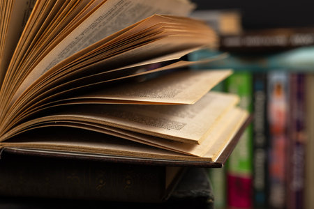 opened book, lying on the bookshelf in library.の写真素材
