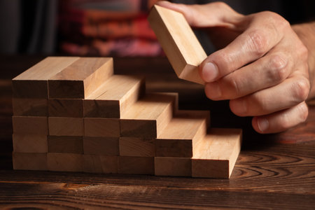 a business man build a blocks wood game.の写真素材