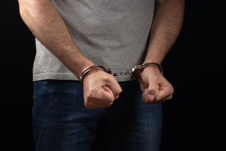 Prisoner male hands criminal with handcuffs.の写真素材