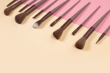 Cosmetic brushes on beige background. Set of makeup brushes.の写真素材