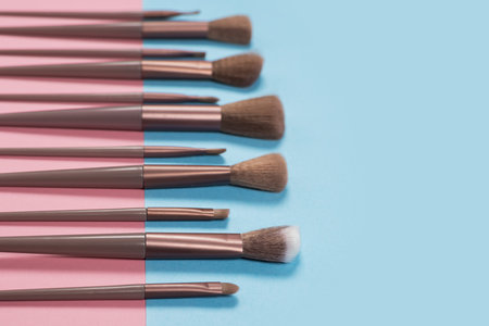 Cosmetics and beauty. Make-up brushes set in row on blue background.の写真素材