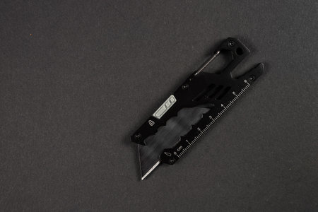 Stationery knife with a blade on a dark background.の写真素材