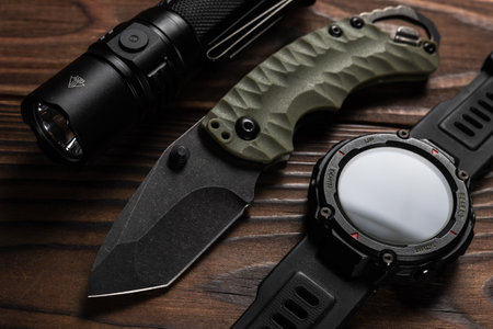 Everyday carry EDC items for men in black color - flashlight, watch and knife. Survival set. Minimal concept.の写真素材