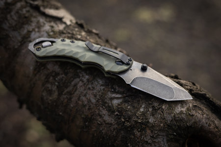 tactical knife on tree in the forest.の写真素材