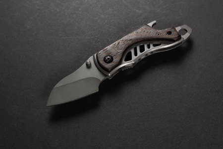 tactical folding knife. EDC knife. on dark background.の写真素材