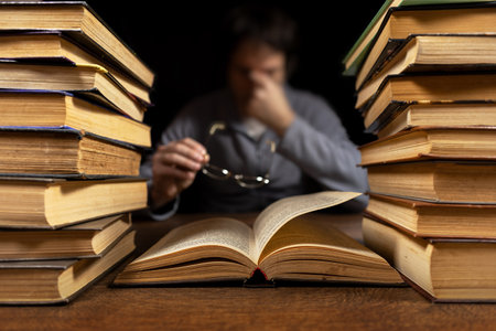 Tired eyes. Man took off his glasses after reading a book,の写真素材