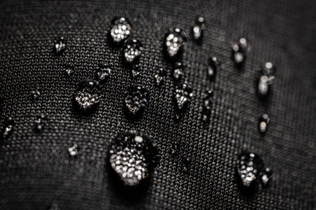 Many water drops on waterproof impregnated fabric.