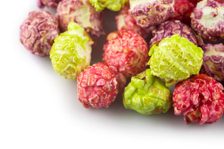 a pile of colorful popcorn on white background.の写真素材
